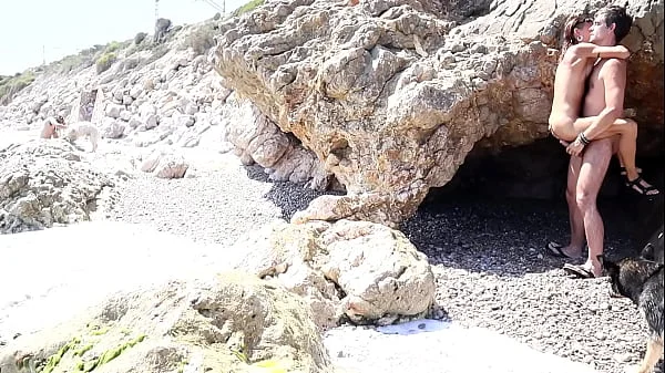 Couple have sex in the beach next to people